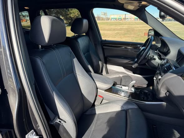 Clean black sedan front seat after detailing