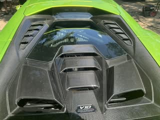Green sports car engine bay after detail